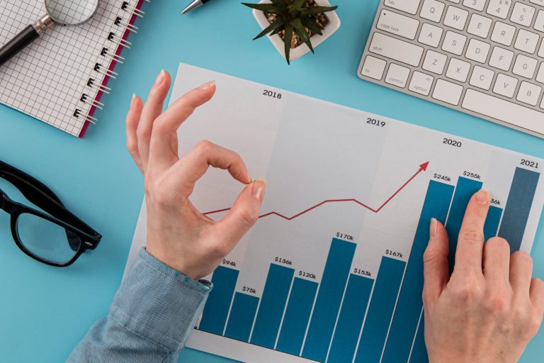 top-view-of-business-items-with-growth-chart-and-hands-giving-okay-sign